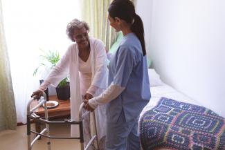 Senior resident at nursing home with nurse